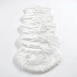Close-up of grey faux fur area rug showing thick high-pile shaggy texture