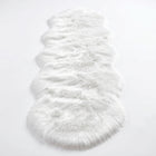 Close-up of grey faux fur area rug showing thick high-pile shaggy texture