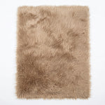 Close-up of grey faux fur area rug showing thick high-pile shaggy texture