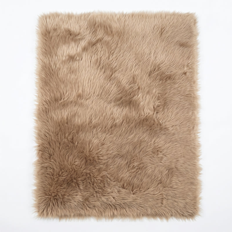 Close-up of grey faux fur area rug showing thick high-pile shaggy texture