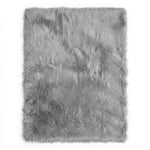 Close-up of grey faux fur area rug showing thick high-pile shaggy texture
