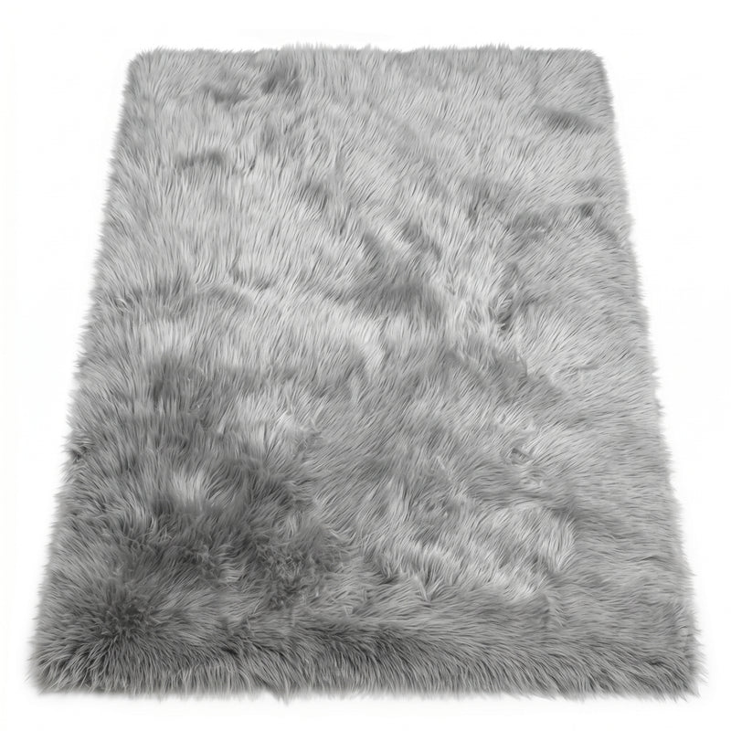 Close-up of grey faux fur area rug showing thick high-pile shaggy texture