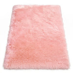 Close-up of grey faux fur area rug showing thick high-pile shaggy texture