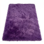 Close-up of grey faux fur area rug showing thick high-pile shaggy texture