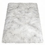 Close-up of grey faux fur area rug showing thick high-pile shaggy texture