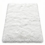 Close-up of grey faux fur area rug showing thick high-pile shaggy texture