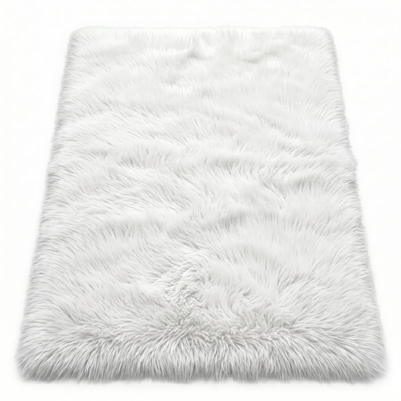 Close-up of grey faux fur area rug showing thick high-pile shaggy texture
