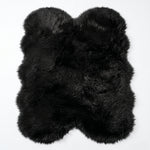 Close-up of grey faux fur area rug showing thick high-pile shaggy texture