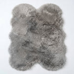 Close-up of grey faux fur area rug showing thick high-pile shaggy texture
