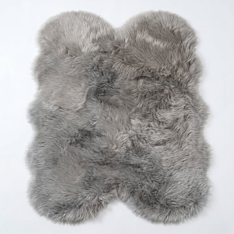 Close-up of grey faux fur area rug showing thick high-pile shaggy texture