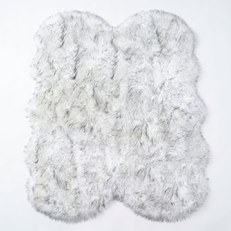 Close-up of grey faux fur area rug showing thick high-pile shaggy texture