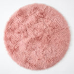 Close-up of grey faux fur area rug showing thick high-pile shaggy texture