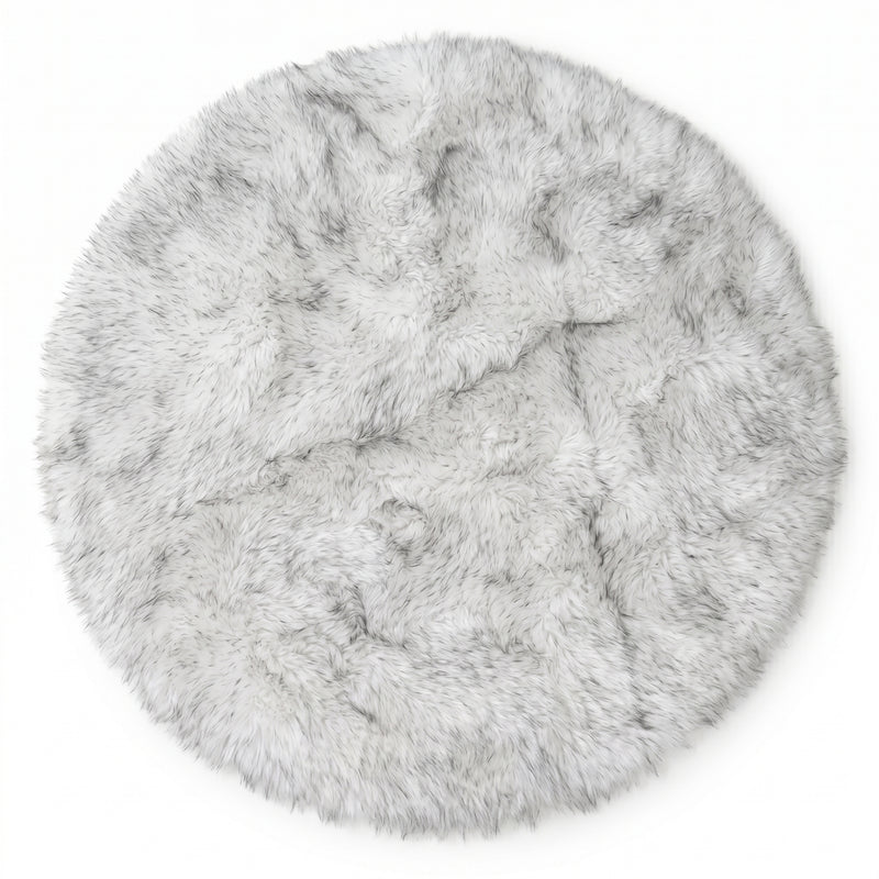 Close-up of grey faux fur area rug showing thick high-pile shaggy texture