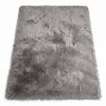 Close-up of grey faux fur area rug showing thick high-pile shaggy texture
