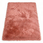 Close-up of grey faux fur area rug showing thick high-pile shaggy texture