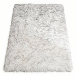 Close-up of grey faux fur area rug showing thick high-pile shaggy texture