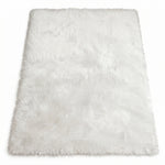 Close-up of grey faux fur area rug showing thick high-pile shaggy texture