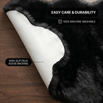 Faux fur area rug shown beside a bed, illustrating machine-washable, vacuum-or-shake-clean maintenance