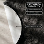 Faux fur area rug shown beside a bed, illustrating machine-washable, vacuum-or-shake-clean maintenance
