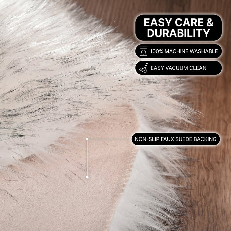 Faux fur area rug shown beside a bed, illustrating machine-washable, vacuum-or-shake-clean maintenance