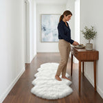 Faux fur sheepskin rug on a closet floor with a woman standing barefoot while reaching for a hanger