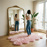 Faux fur sheepskin rug on a closet floor with a woman standing barefoot while reaching for a hanger