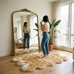Faux fur sheepskin rug on a closet floor with a woman standing barefoot while reaching for a hanger