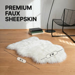 Faux fur sheepskin rug runner at the foot of a bed, labeled 72 inches long by 24 inches wide with slippers resting on top