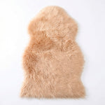 Faux fur sheepskin rug in white and yellow, shown flat from above in its natural pelt shape