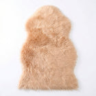 Faux fur sheepskin rug in white and yellow, shown flat from above in its natural pelt shape