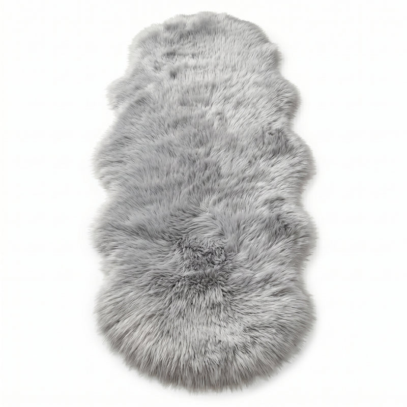 Faux fur sheepskin rug in white and yellow, shown flat from above in its natural pelt shape
