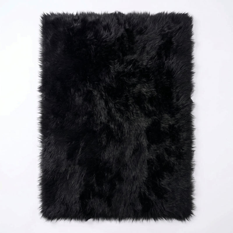 Faux fur sheepskin rug in white and yellow, shown flat from above in its natural pelt shape