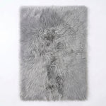 Faux fur sheepskin rug in white and yellow, shown flat from above in its natural pelt shape