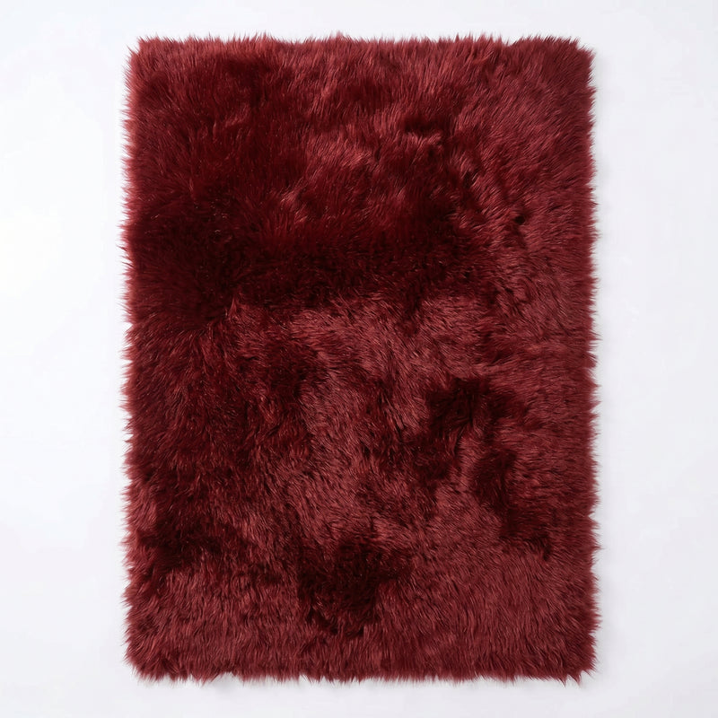 Faux fur sheepskin rug in white and yellow, shown flat from above in its natural pelt shape