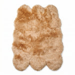 Faux fur sheepskin rug in white and yellow, shown flat from above in its natural pelt shape