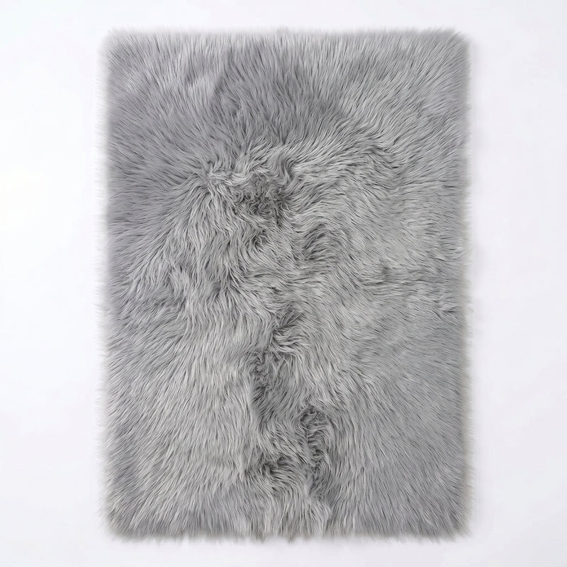 Faux fur sheepskin rug in white and yellow, shown flat from above in its natural pelt shape
