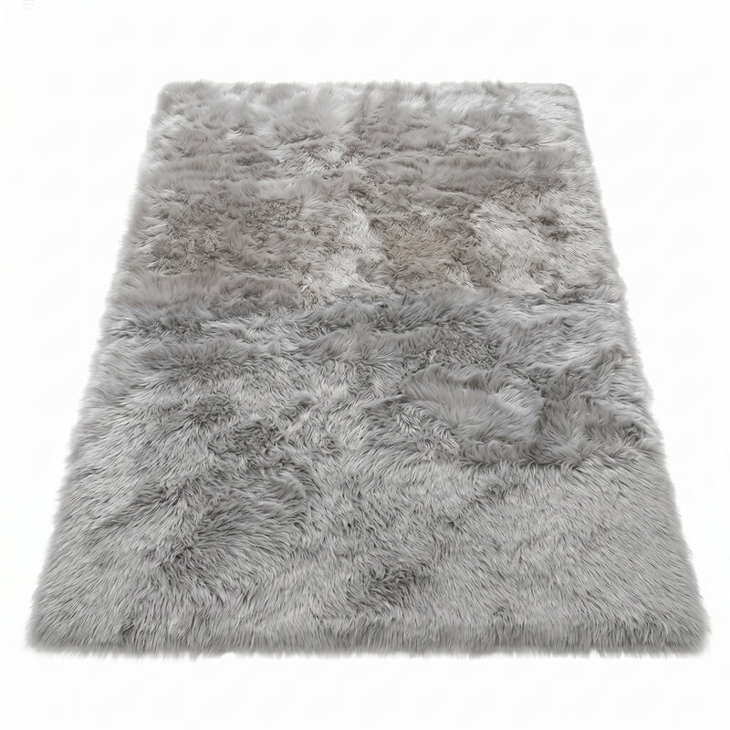 Faux fur sheepskin rug in white and yellow, shown flat from above in its natural pelt shape