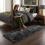 Ultra-soft faux sheepskin area rug in white placed in living room beside armchair
