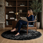 Ultra-soft faux sheepskin area rug in white placed in living room beside armchair