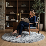 Ultra-soft faux sheepskin area rug in white placed in living room beside armchair