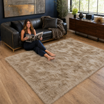 Ultra-soft faux sheepskin area rug in white placed in living room beside armchair