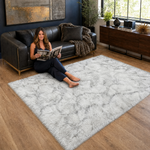 Ultra-soft faux sheepskin area rug in white placed in living room beside armchair