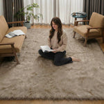 Ultra-soft faux sheepskin area rug in white placed in living room beside armchair