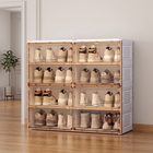 Foldable shoe cabinet with clear brown-tinted doors holding sneakers in a white entryway