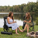 Woman relaxing in a low folding beach chair at the beach