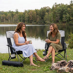 Woman relaxing in a low folding beach chair at the beach