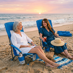 Woman relaxing in a low folding beach chair at the beach