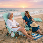 Woman relaxing in a low folding beach chair at the beach