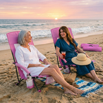 Woman relaxing in a low folding beach chair at the beach