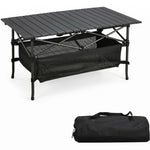 Black aluminum folding camping table with roll-up top and mesh storage basket